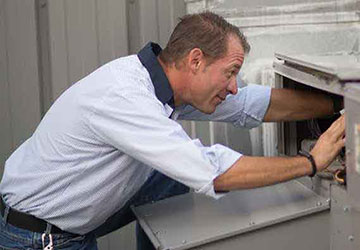 Man repairing HVAC unit
