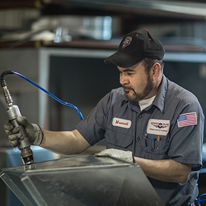 Anderson Air Corps employee holding equipment