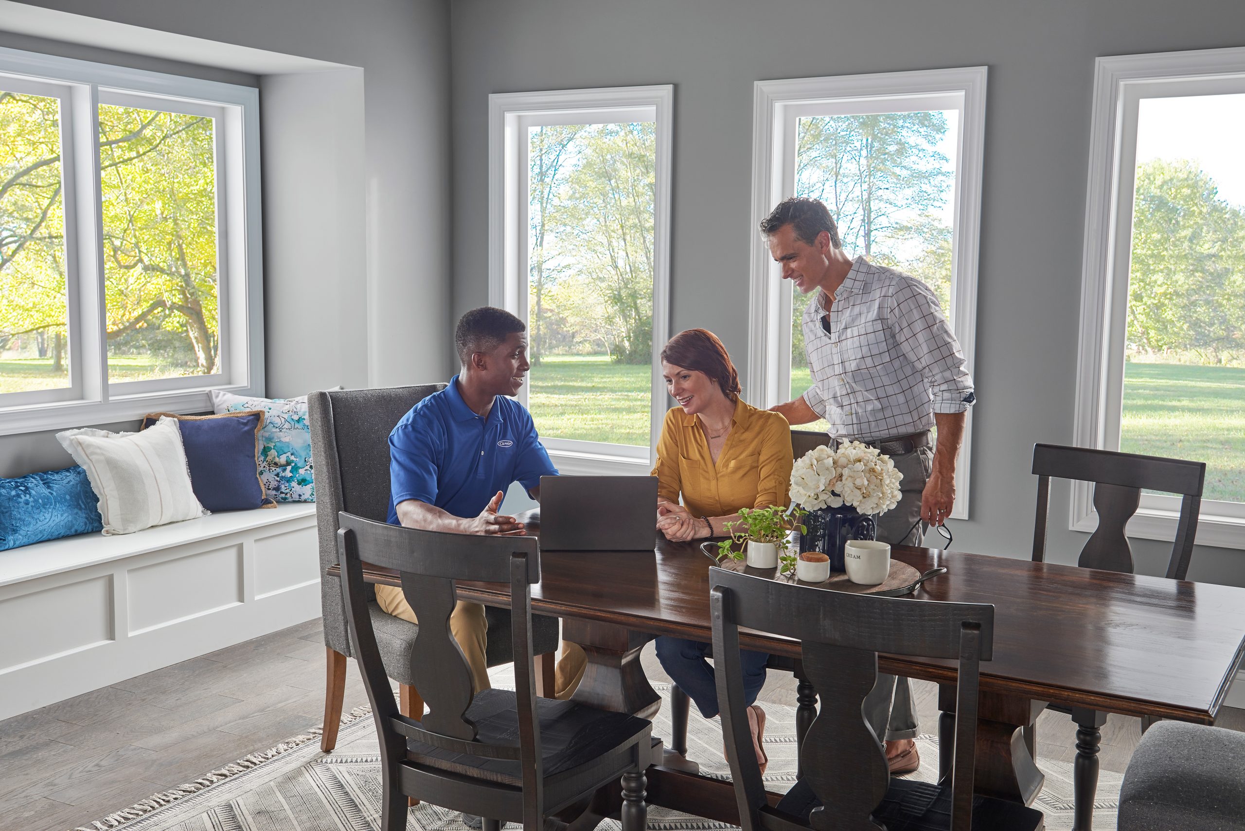 Dealer_couple_dining-table_laptop - Anderson Air Corps Legal Action Air Conditioning Inc. Anderson Air Corps Legal Action Air Conditioning Inc. | Heat Pump Installation & Repair