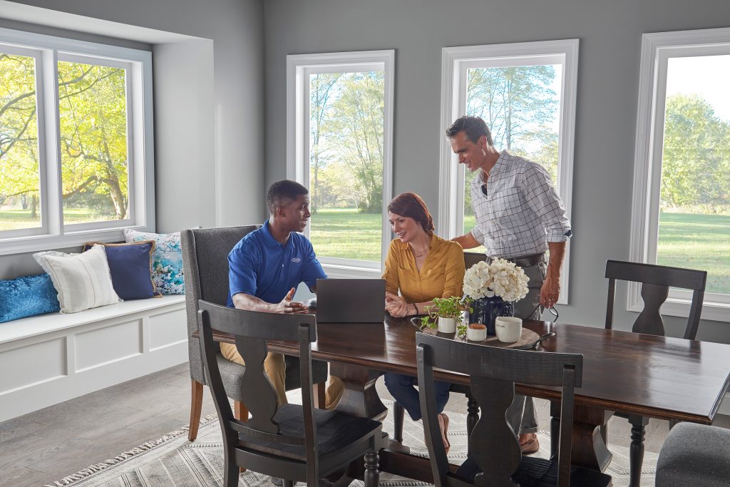 Dealer_couple_dining-table_laptop - Anderson Air Corps Legal Action Air Conditioning Inc. Anderson Air Corps Legal Action Air Conditioning Inc. | Indoor Air Quality Maintenance Services