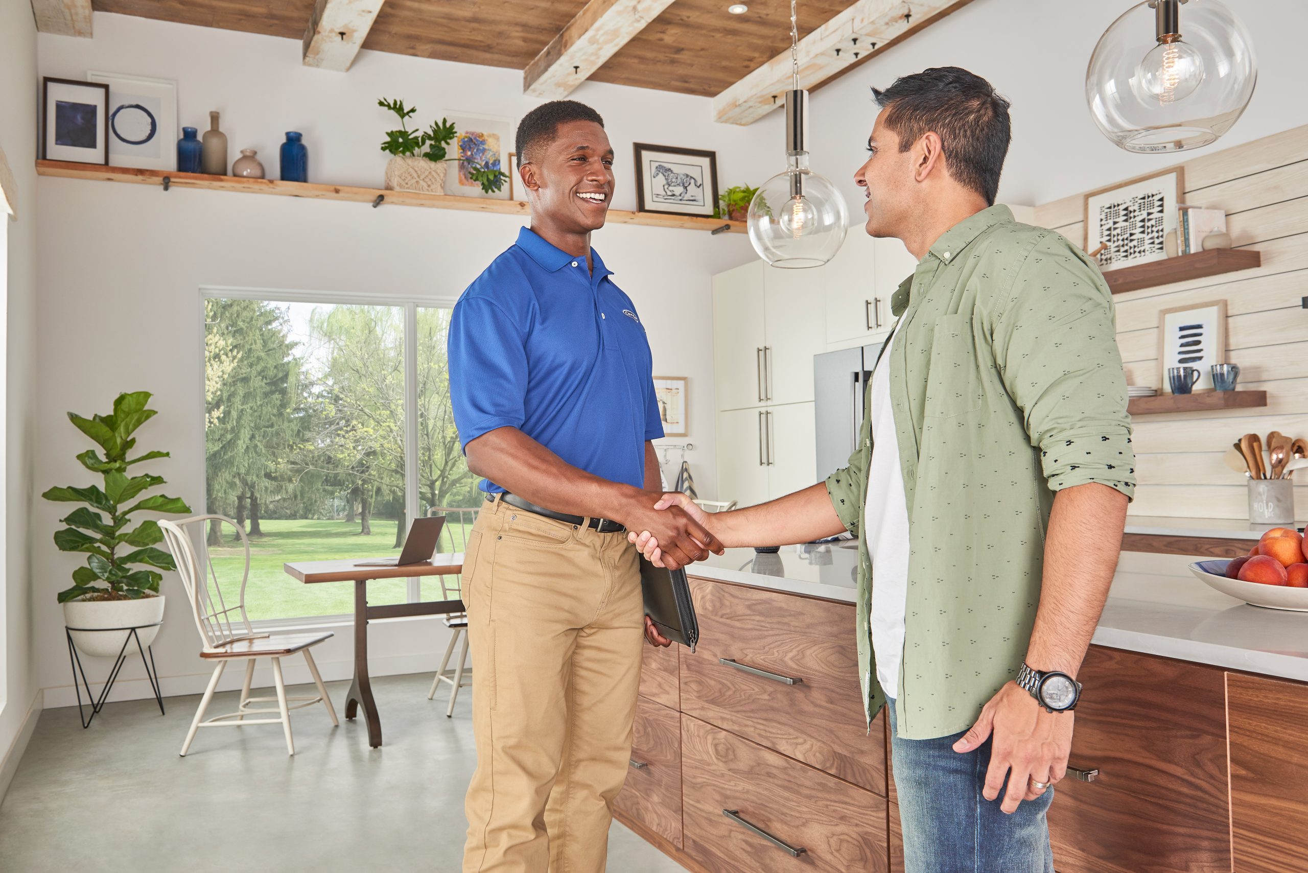 Dealer_man_handshake_kitchen - Anderson Air Corps Legal Action Air Conditioning Inc. Anderson Air Corps Legal Action Air Conditioning Inc. | Heat Pump Installation & Repair