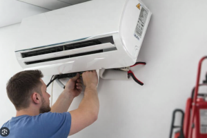 Technician installing ductless mini split air conditioning unit
